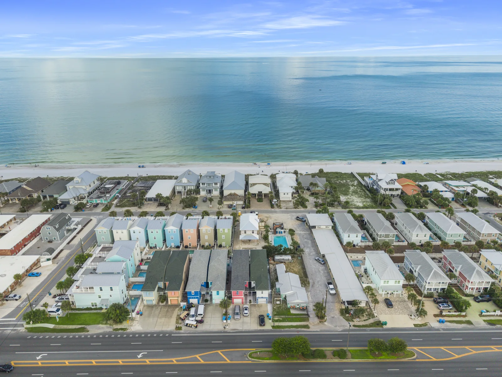 Aerial drone photo of a Panama City Beach FL neighborhood with the Gulf of Mexico beyond