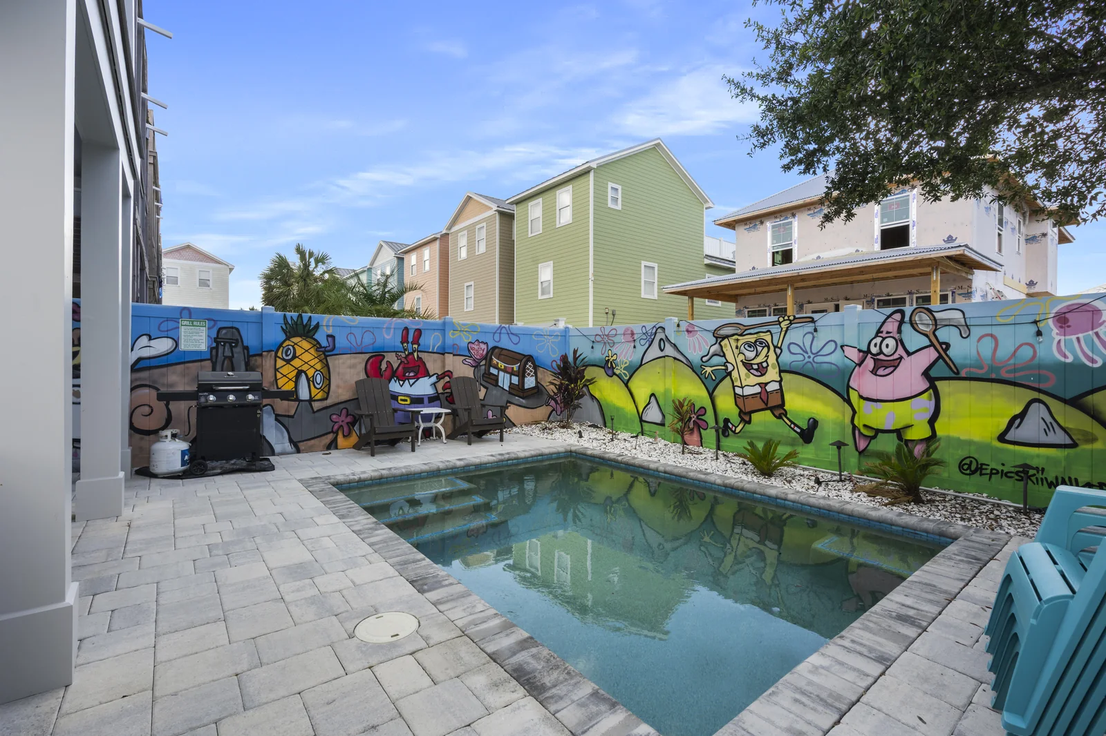 Pool courtyard with tropical graffiti mural wall